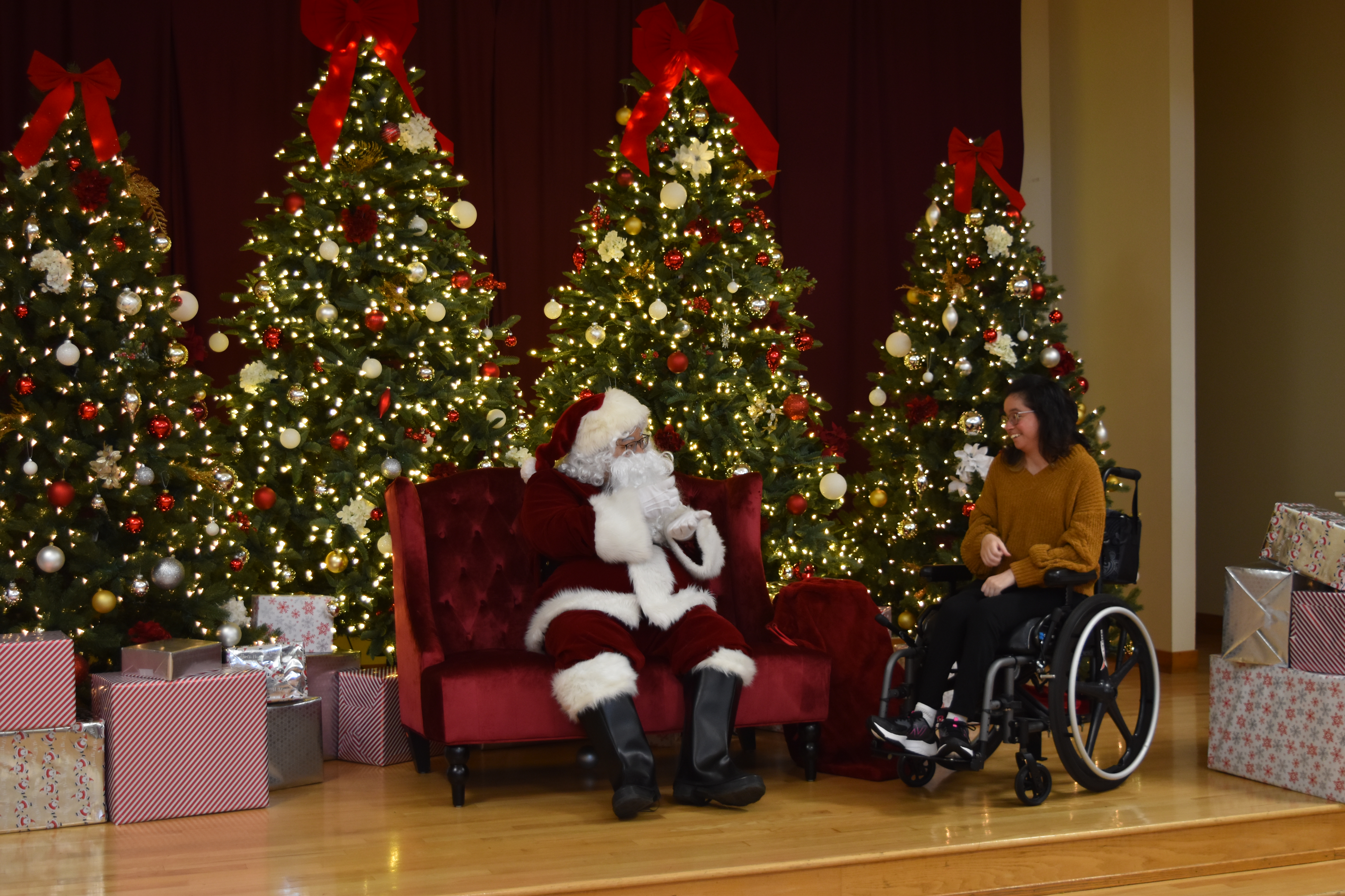 Santa speaking with a woman in a wheelchair